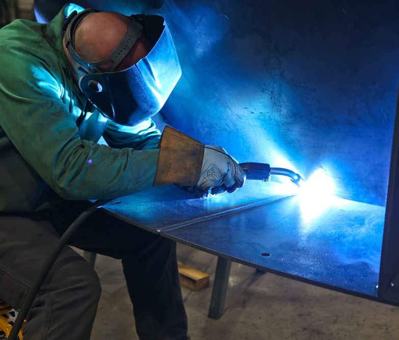 individual with mask welding